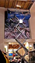 30&rsquo; scissors lift used to install banner on a stretch frame in Seattle, WA